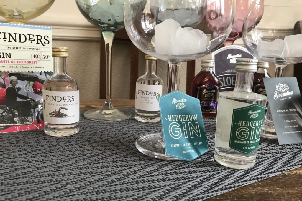 Bottles of Slowmotion Gin's on table with glasses